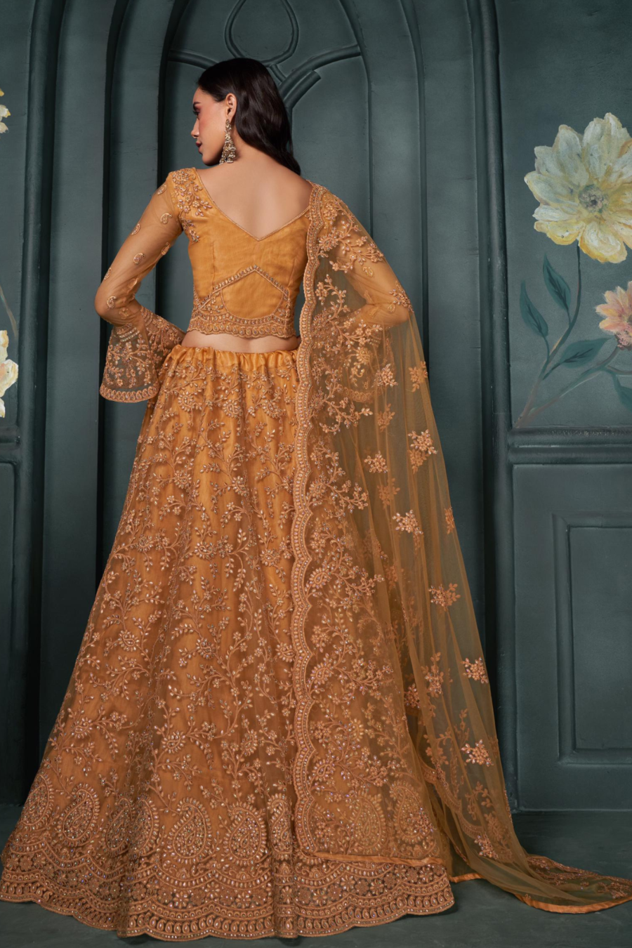 Elegant Mustard Net Lehenga Adorned With Sparkling Stone